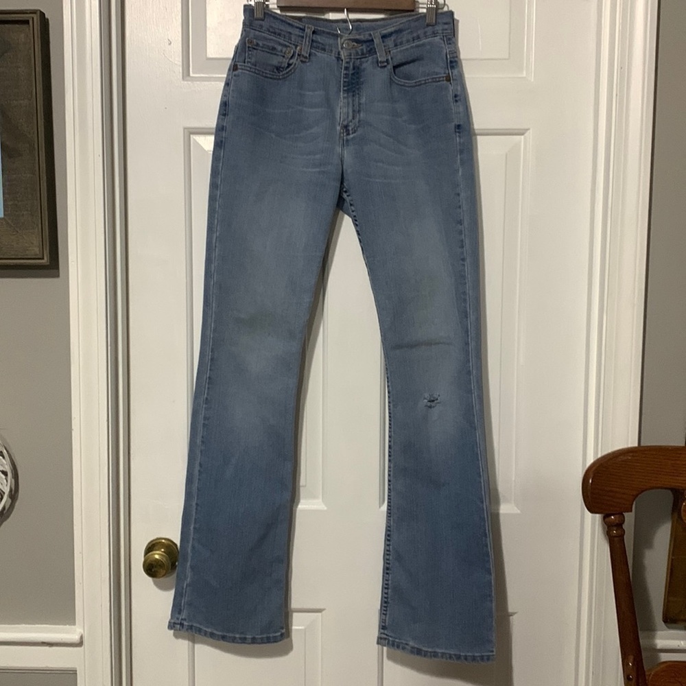 Levi’s 515 faded bootcut jeans with small hole at left knee size Large